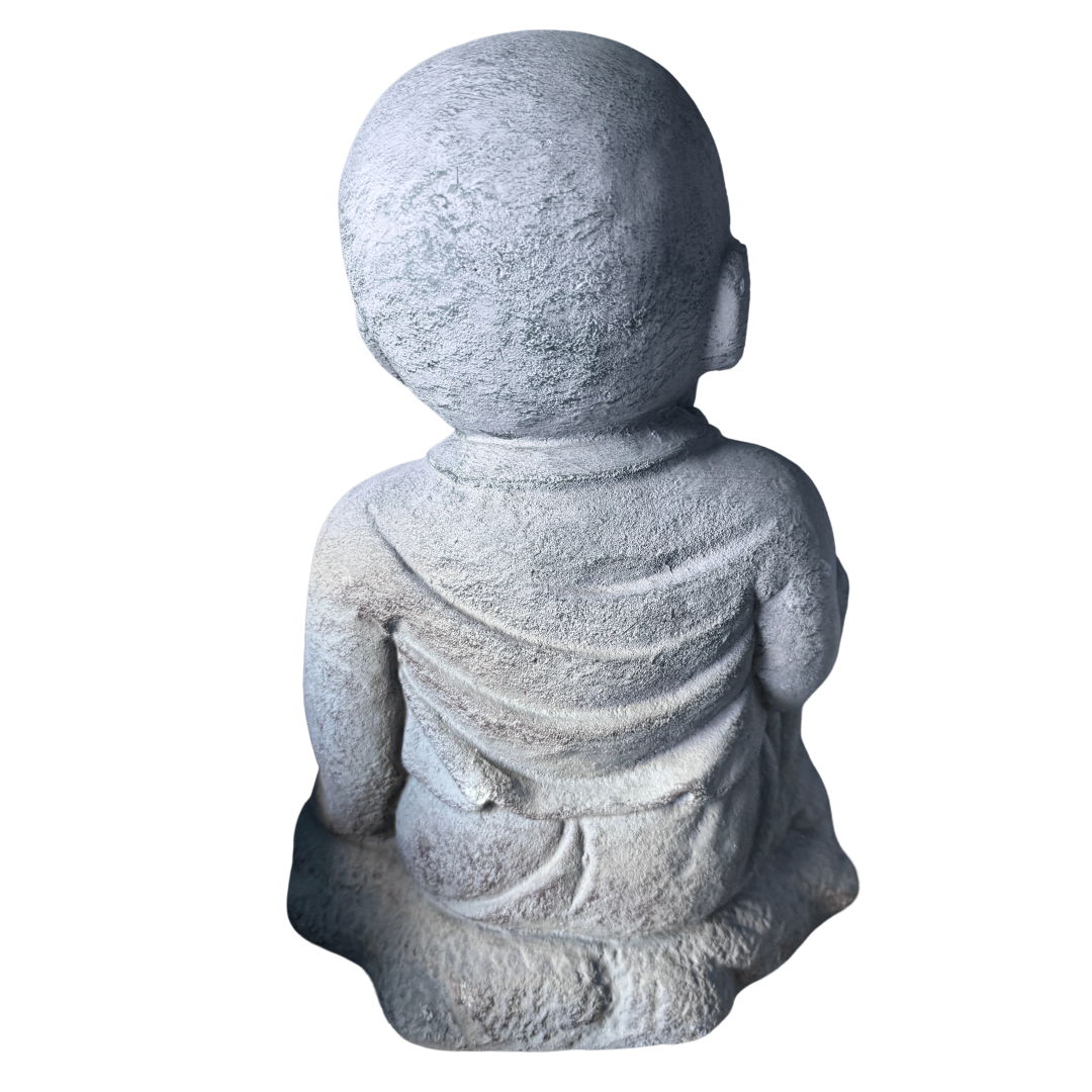 Rear view of a grey seated figurine showing textured detailing and folds across the robes.