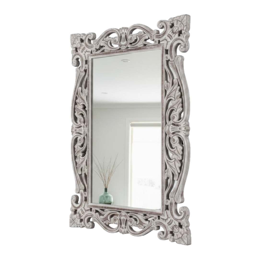 Decorative mirror with intricate silver frame on a white background