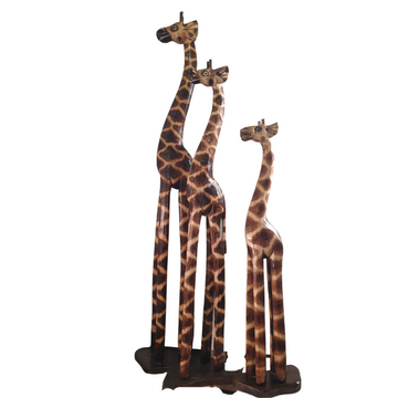 Wooden giraffe statues standing together large medium and small on a white background.