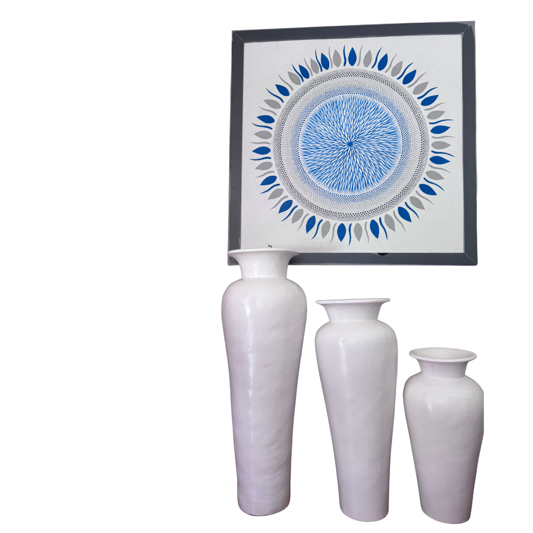Set of three white vases with a framed abstract artwork on a white background