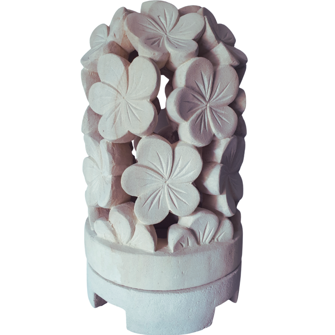 Decorative limestone lantern with floral designs on a white background