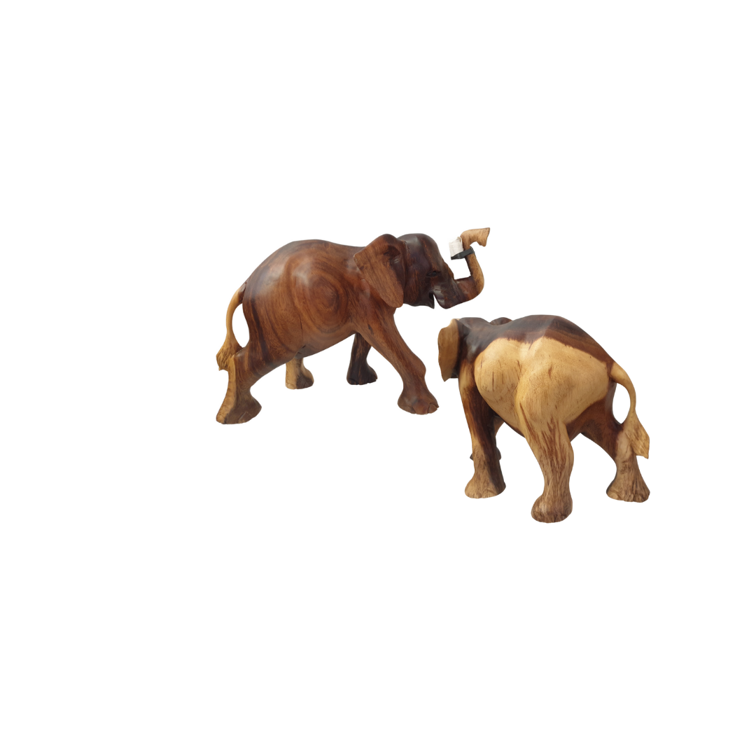 Two solid wood elephant figurines side by side on a white background, showing the natural two-tone grain variation — the is style 3 showing each side of the piece 