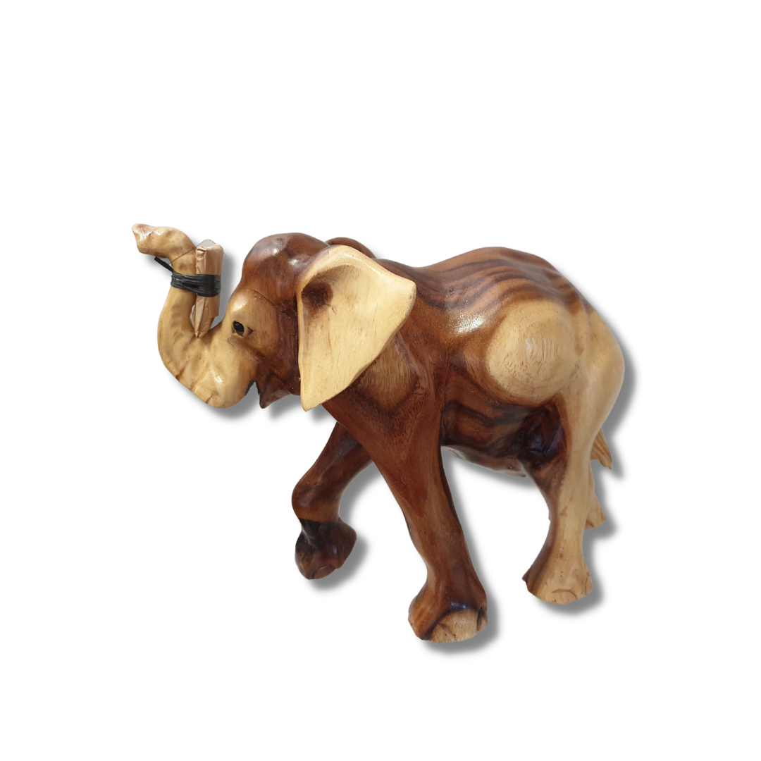 Solid wood elephant figurine with trunk raised, showing natural two-tone grain with warm brown and pale cream tones. Tusks included separately for safe delivery STYLE 4