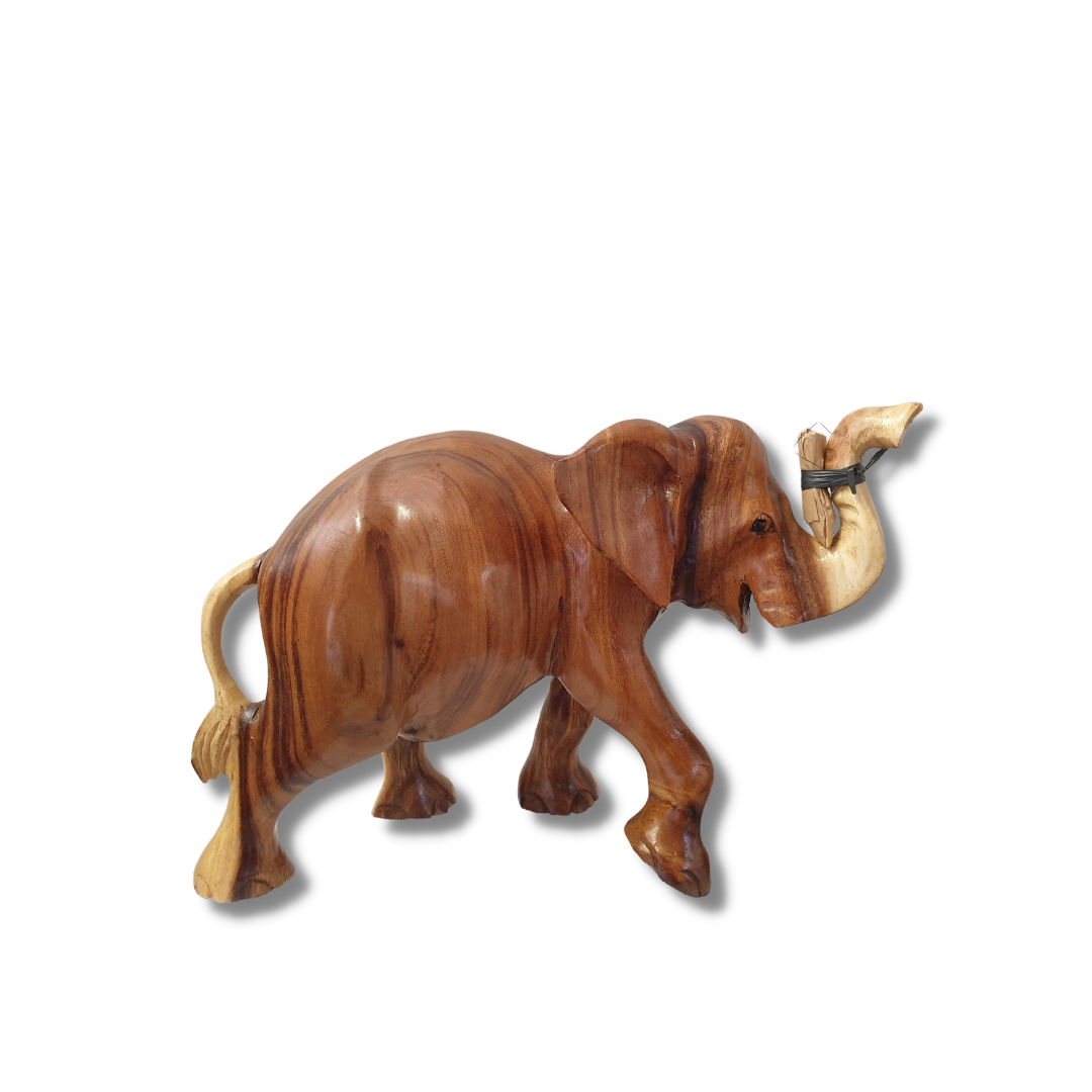 Side view of a hand-carved figurine with trunk raised and ivory tusks attached, warm mid-brown grain with natural wood striping, on a white background.s STYLE 4