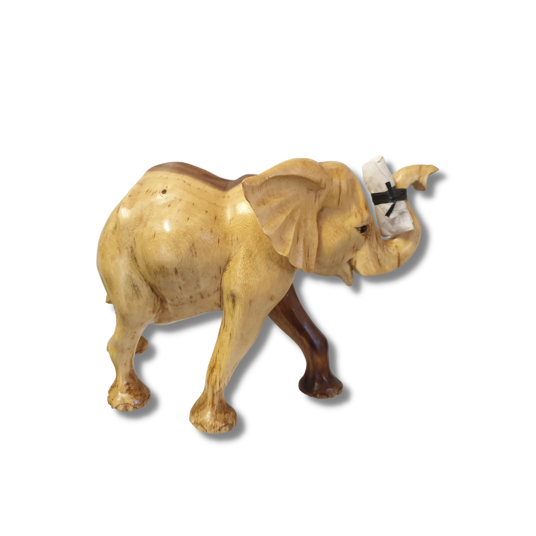 Side view of a hand-carved figurine with trunk raised, predominantly pale golden grain with darker brown legs and trunk, tusks included separately for safe delivery, on a white background.STYLE 2