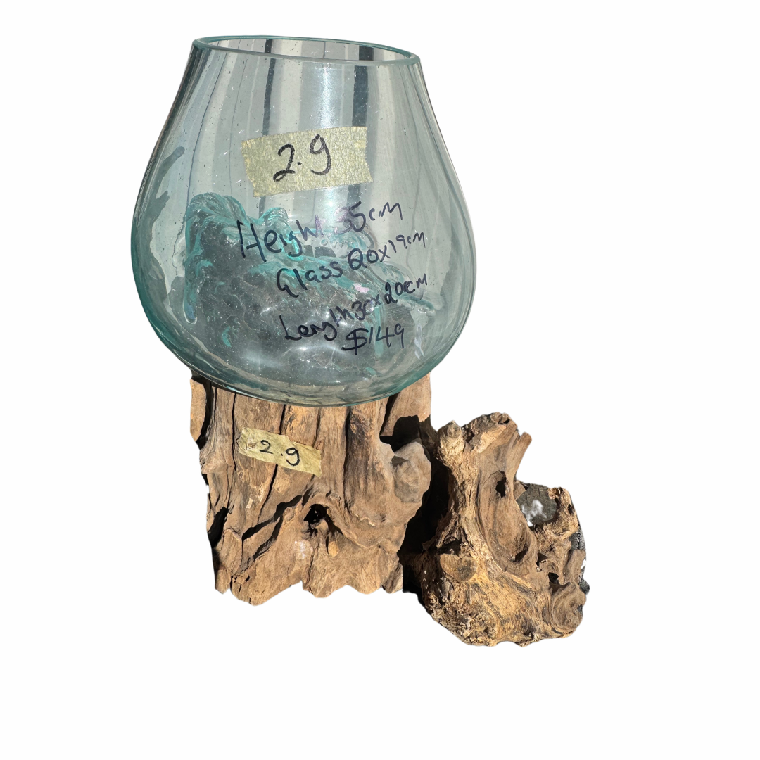 A clear glass bowl-shaped vase or tumbler with a rounded base, displayed on a natural driftwood stand against a white background. Handwritten text on the glass reads 'High Bess Glass Bowl' and includes a price, with small paper labels marked '2-9' on both the glass and the wood base.