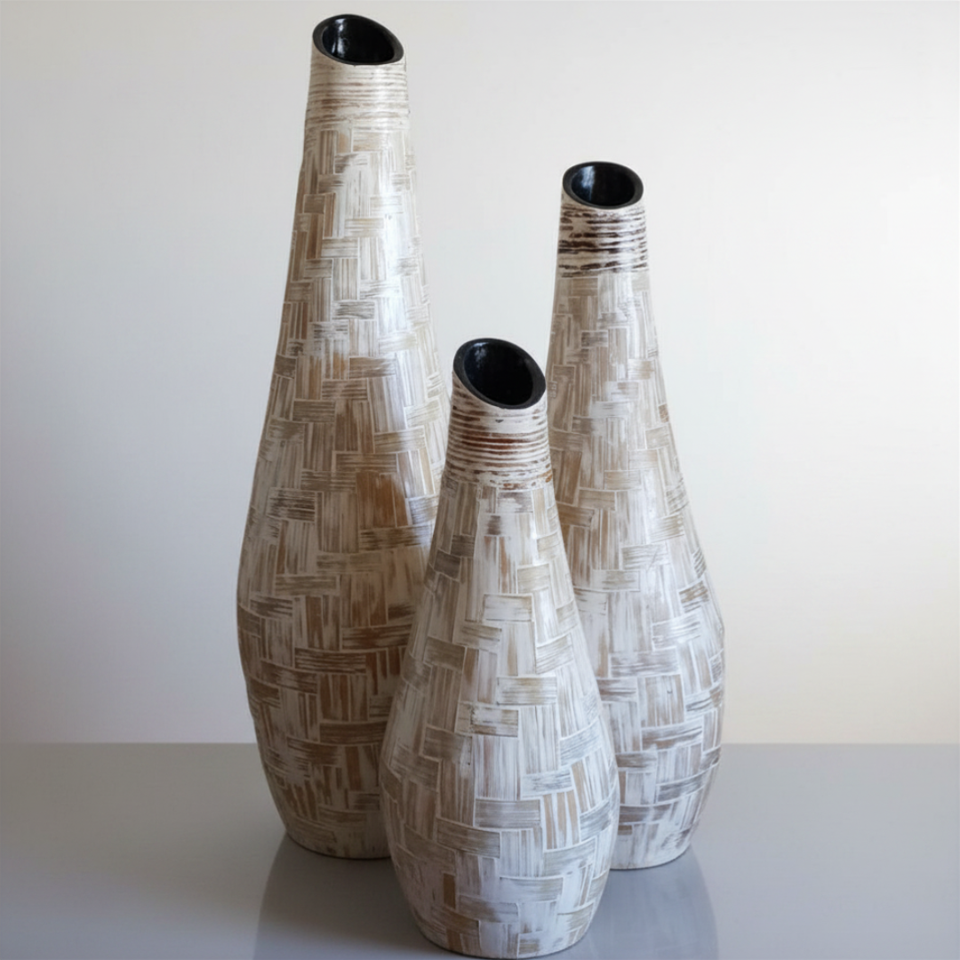 Set of three terracotta patchwork vases in graduated heights on a white background