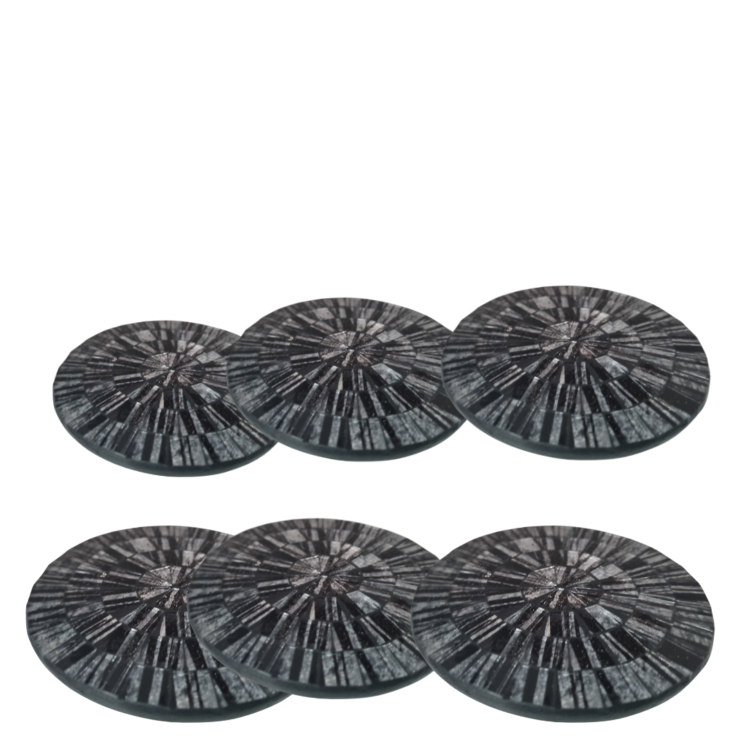 A set of round mosaic drink coasters in various grey colors