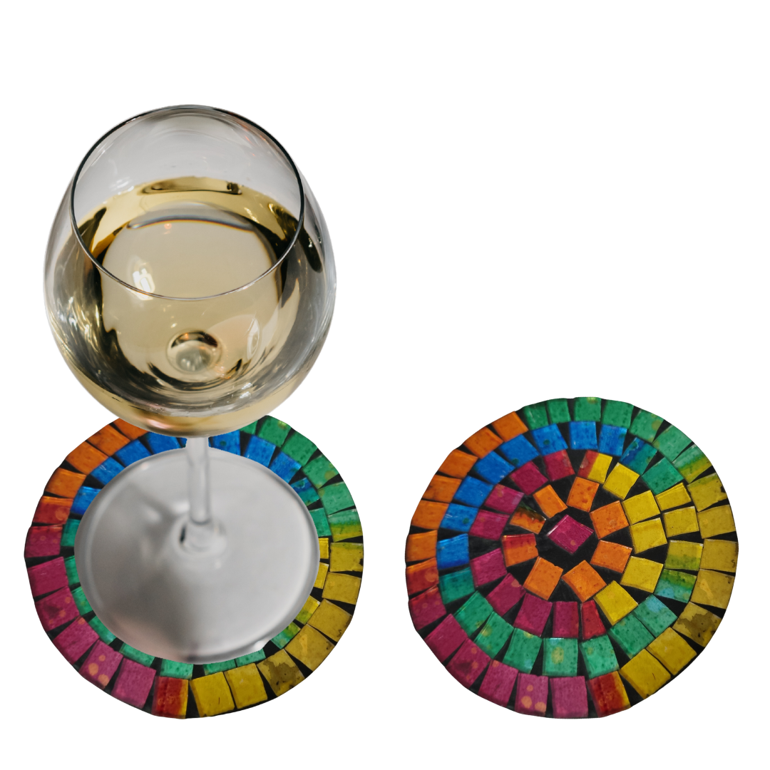 Two round  with vibrant rainbow concentric tile rings in pink, orange, yellow, green and blue, one with a white wine glass resting on it