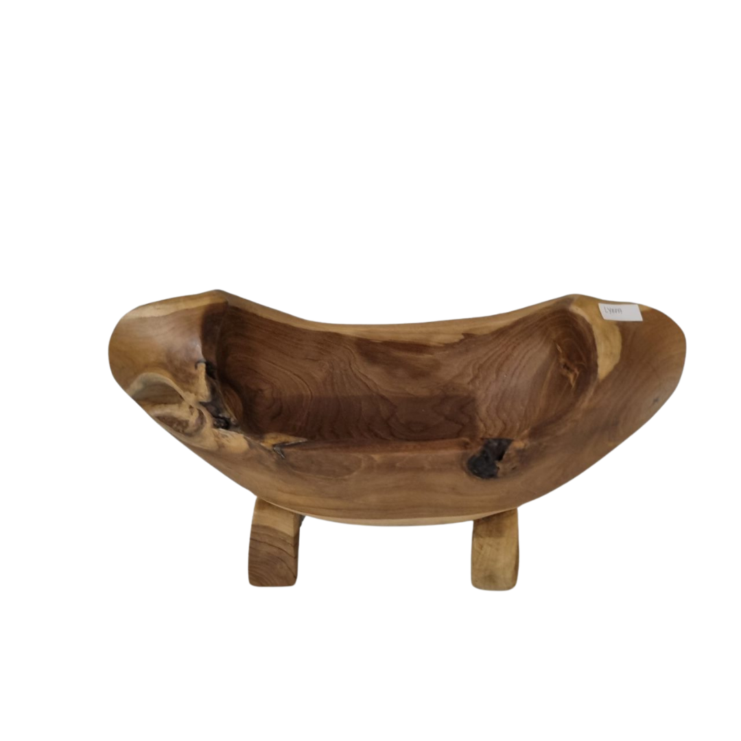 wooden boat shaped bowl on white back wall 