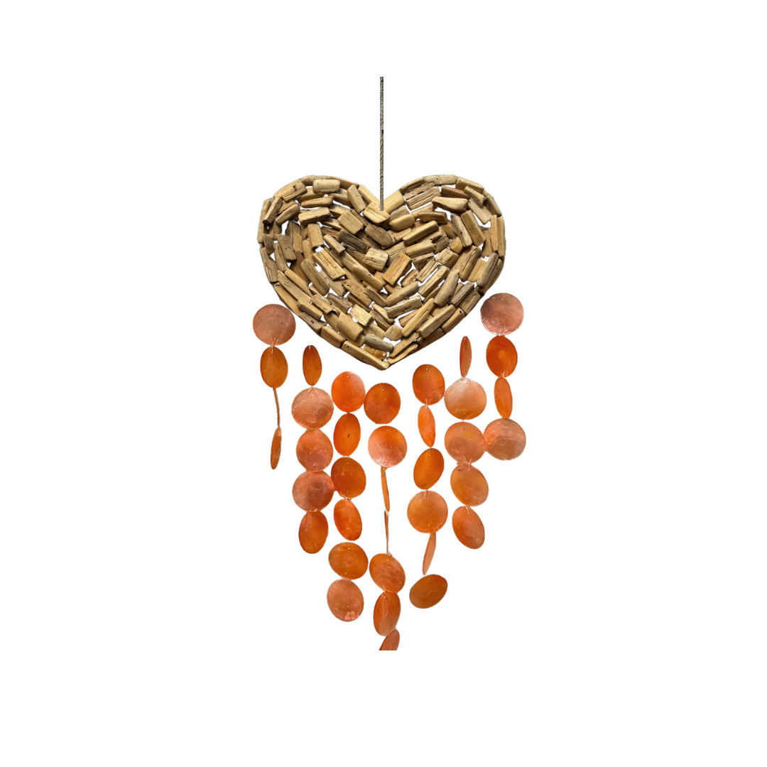 A hanging heart-shaped wind spinner made from natural wood chips, with dangling orange and brown circular discs below, shown against a plain white background.