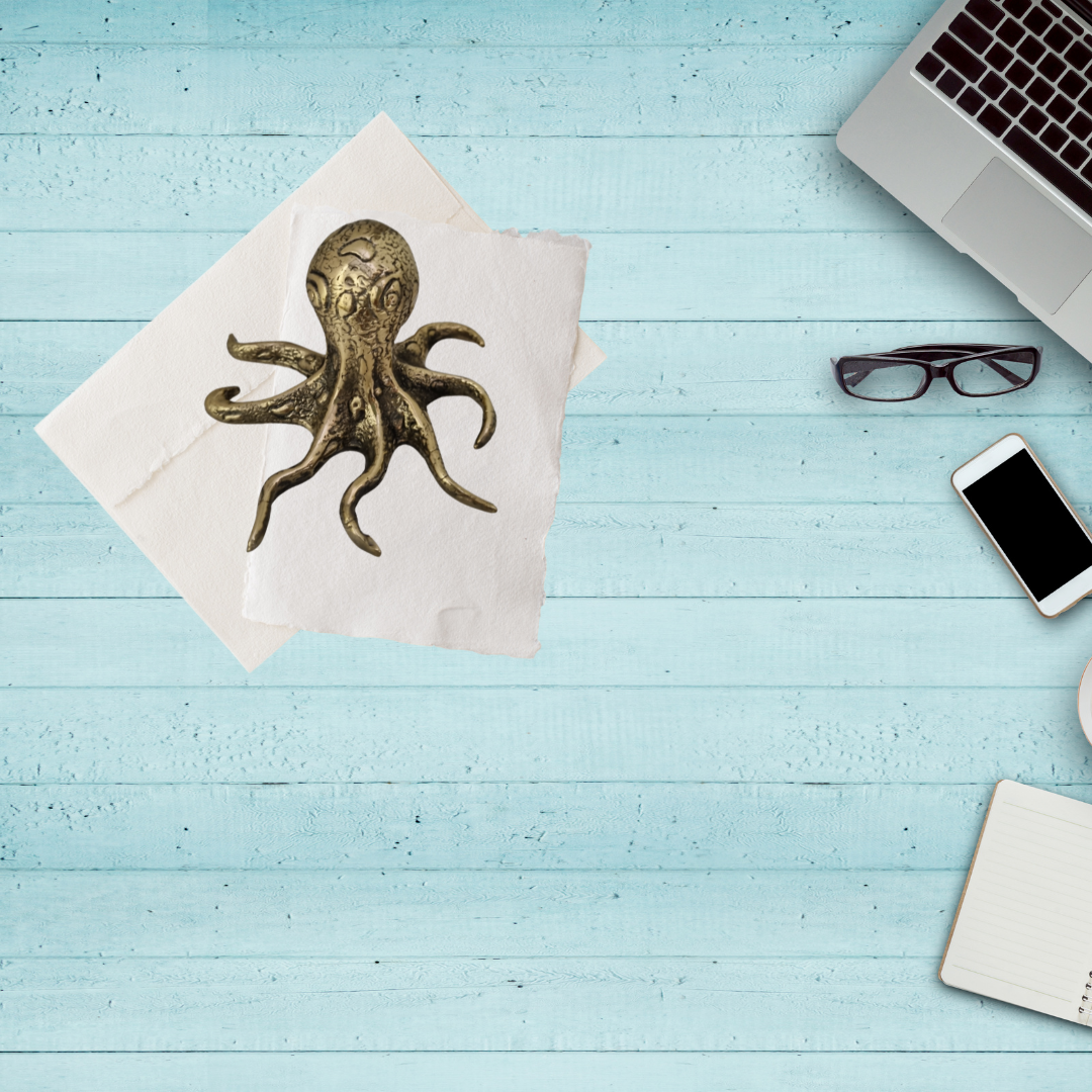 Figurine set on a desktop wth a few office pieces scattered around 