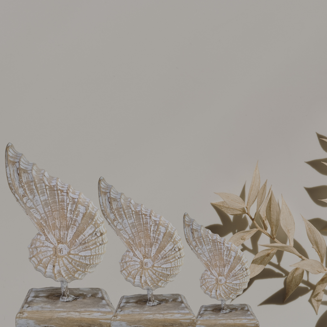 A handcrafted wooden conch shell decoration on a stand, with a natural beige and white color finish.