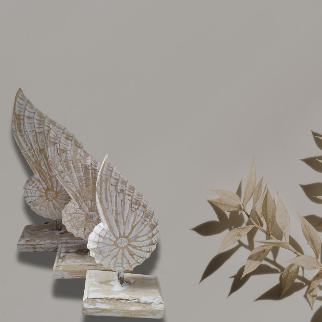 A handcrafted wooden conch shell decoration on a stand, with a natural beige and white color finish.