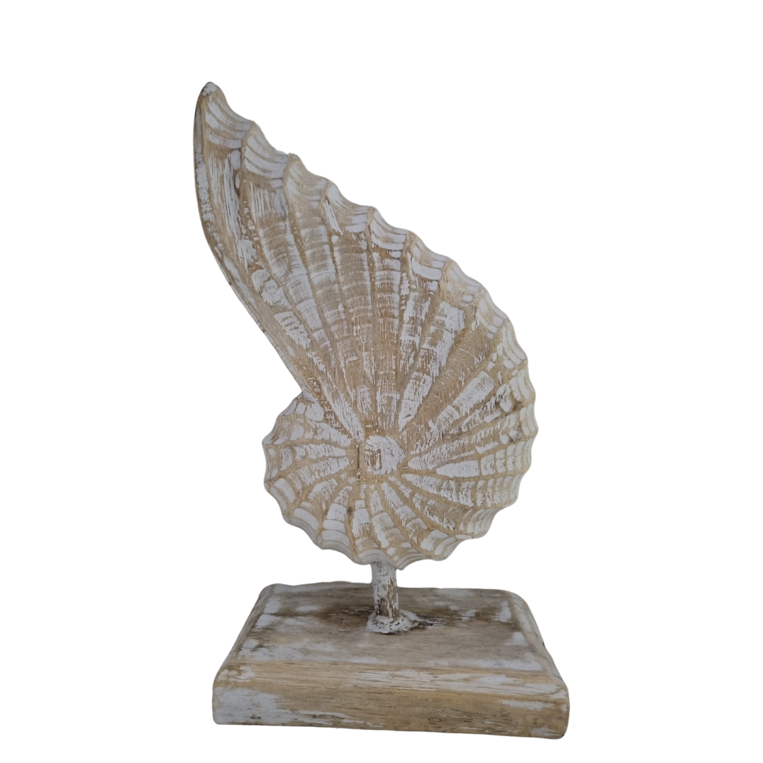 A handcrafted wooden conch shell decoration on a stand, with a natural white  wash white back drop 