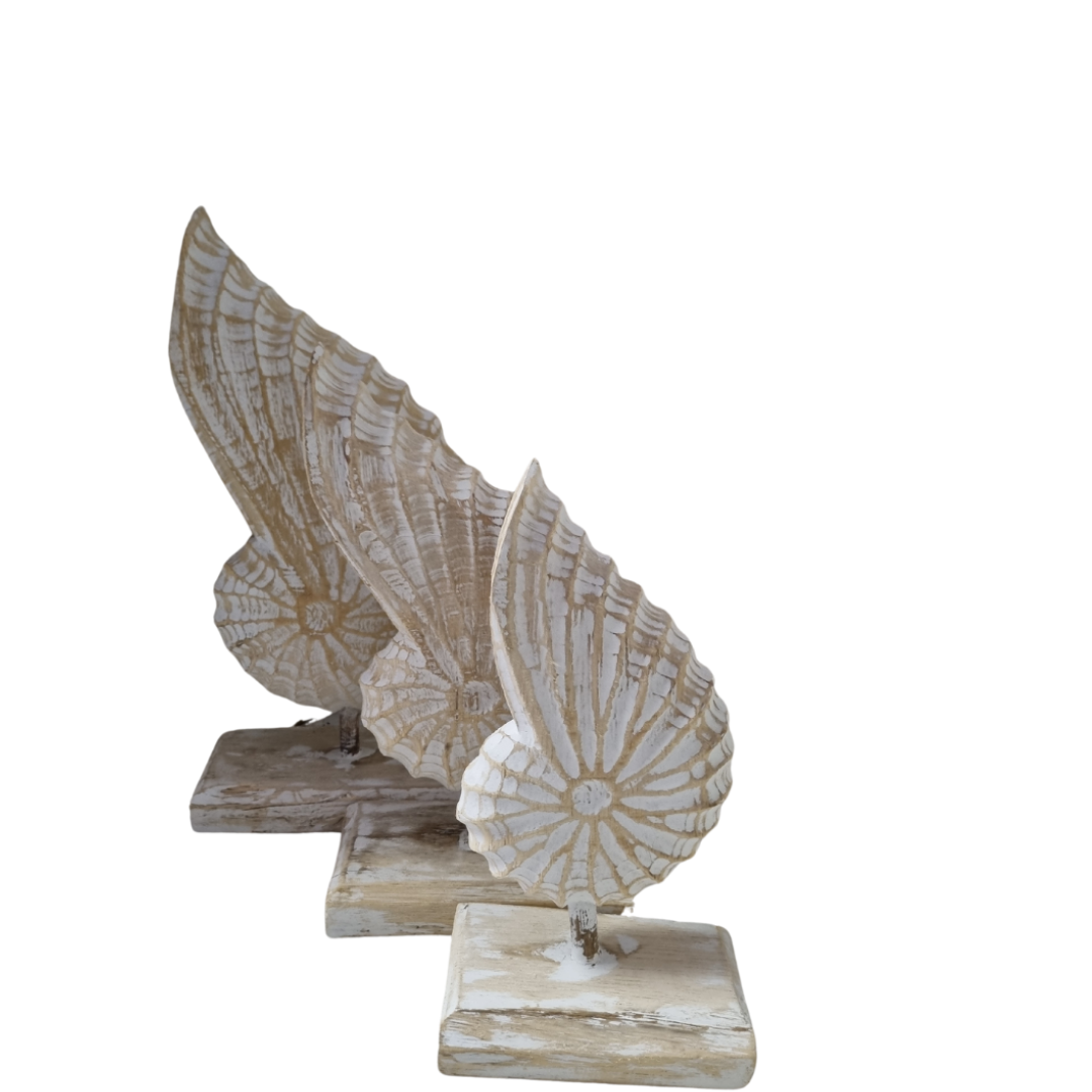 3 wooden conch shell decor pieces all set on a stand on a white back ground 