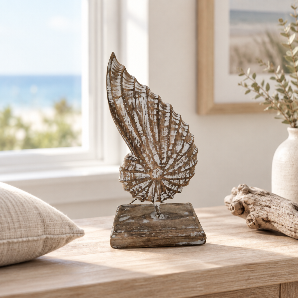 styled single brown wash shell ornament on stand on a coastal console shelf