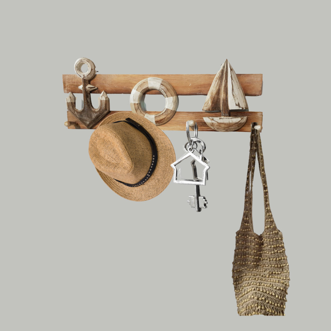 Wall-mounted wooden hook with various items including a hat, bag, and key holder on a gray background