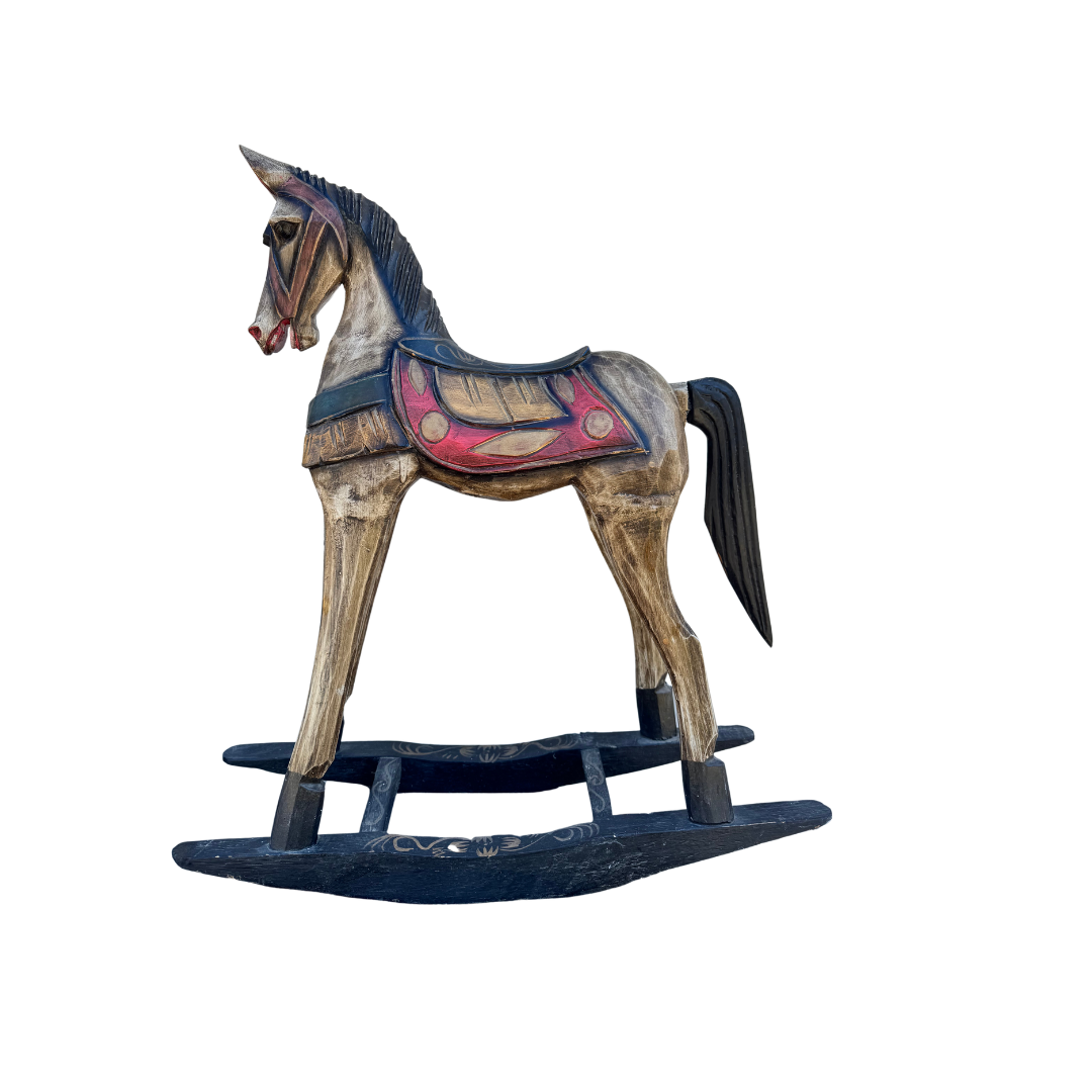 Painted rocking horse decorative feature with weathered tan body, jewel tone saddle detailing, black mane and tail, and black rocker base, isolated on a white background.