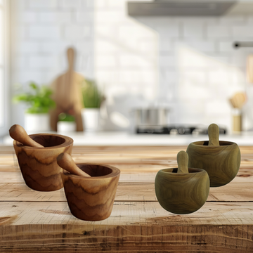 Set of wooden mortars and pestles on a kitchen counter with a blurred background