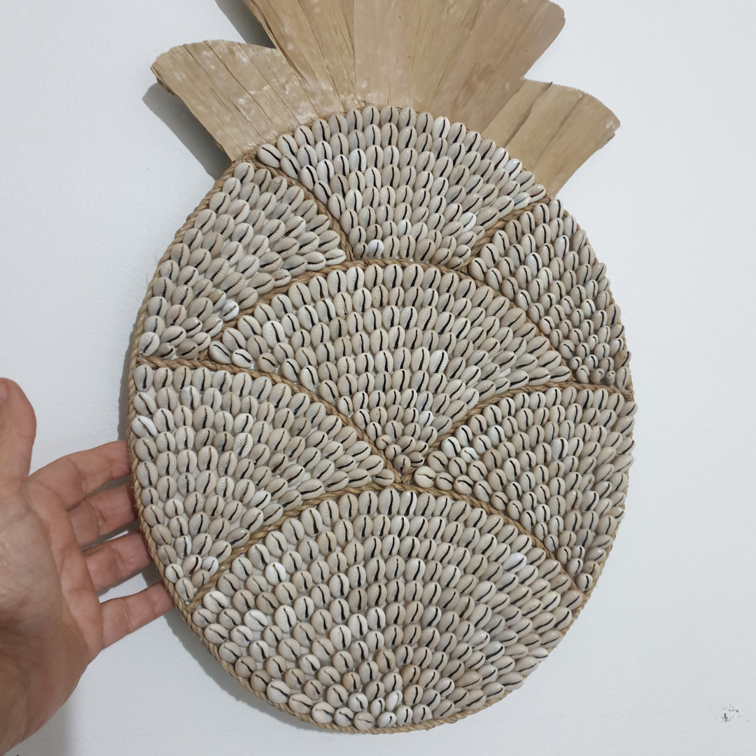 Pineapple-shaped decorative item made of woven material on a white background