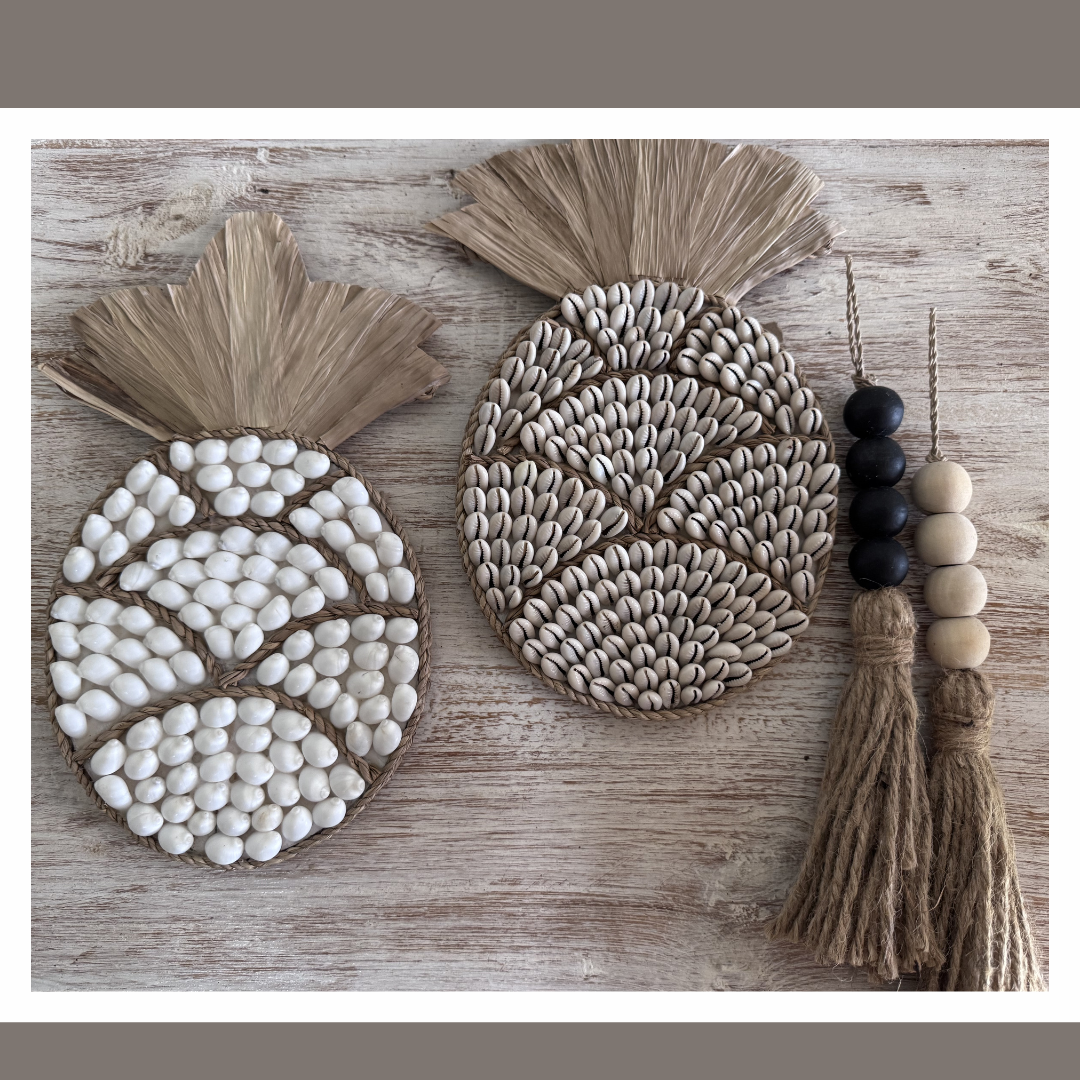 table top decor pineapple designs or can be used as wall art  with tassels on a wooden surface