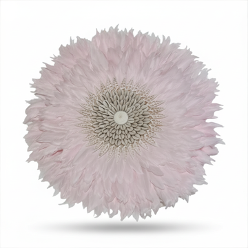 Close-up of a pink feather art with a white center on a white background