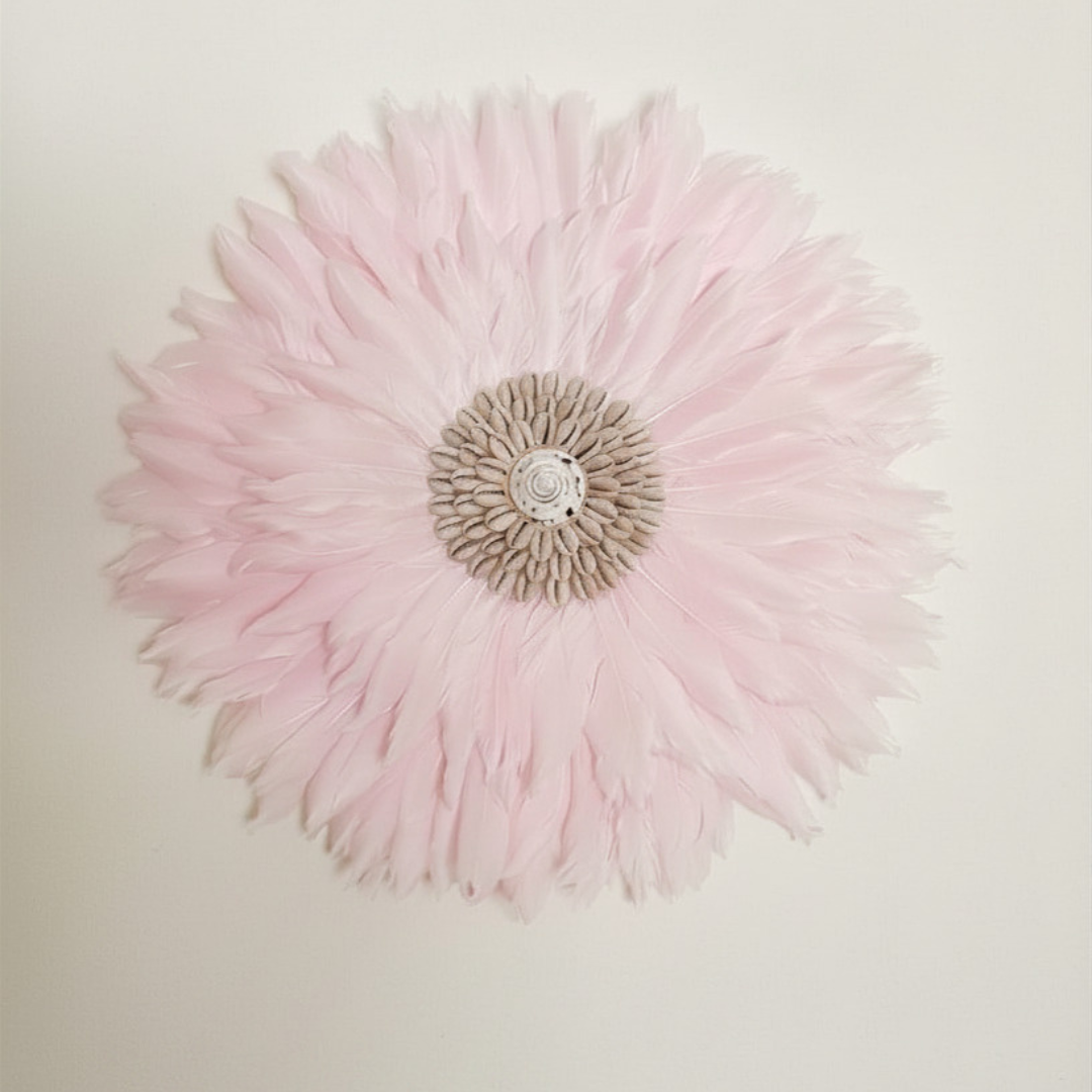 Pink JUJU hat wall art 35cm hung on a white wall showing soft pink feathers and natural cowrie shell 35x35cm centrepiece