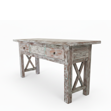 Reclaimed boat wood console table with distressed white paint finish and X-cross legs shown at an angle on white background