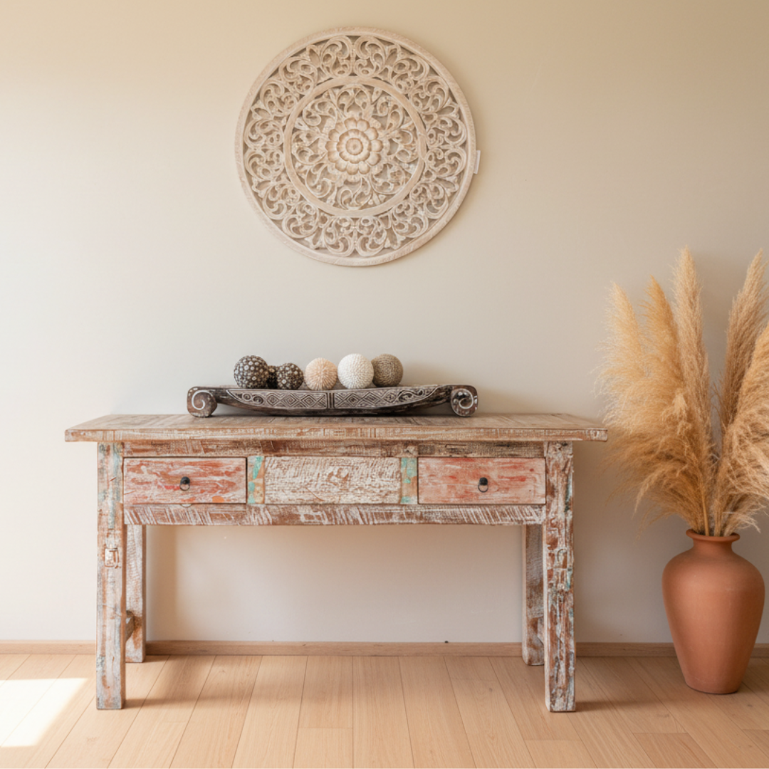 Reclaimed boat wood console table with distressed multicolour finish styled in a coastal hallway with mandala wall art and pampas grass
