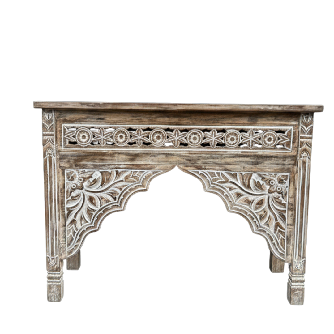 Decorative wooden console table with intricate carvings on a white background