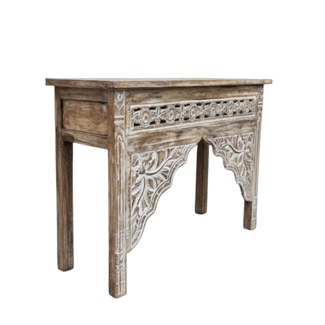 Wooden side table with intricate carvings on a white background