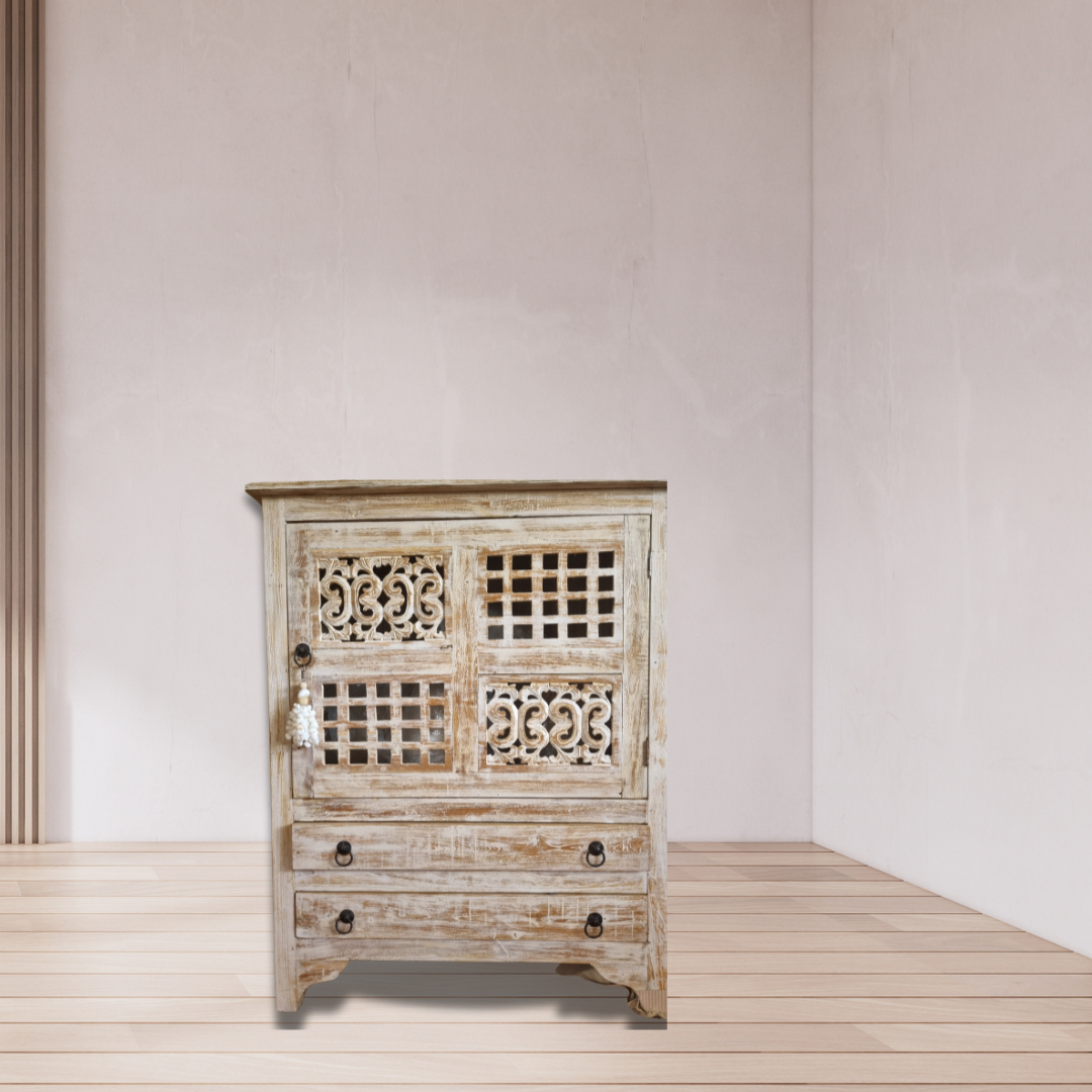 A rustic reclaimed teak wood cabinet with intricate carvings, featuring a white-wash finish and traditional hardware.
