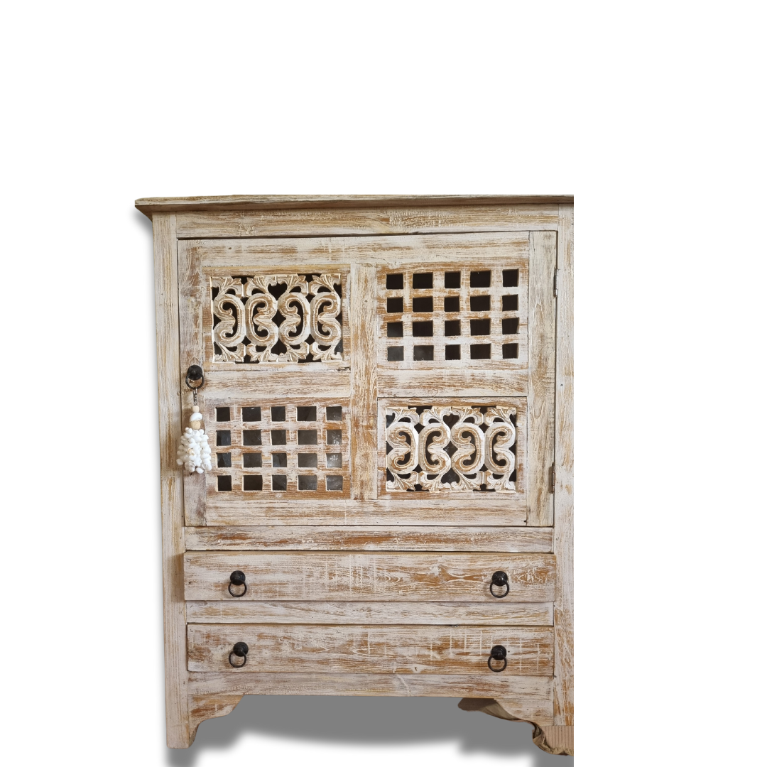A rustic reclaimed teak wood cabinet with intricate carvings, featuring a white-wash finish and traditional hardware.