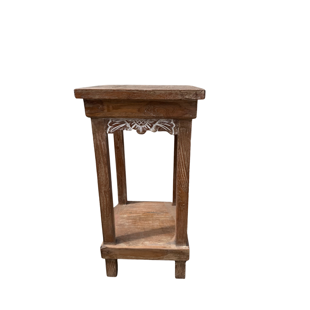 Wooden side table with decorative carvings on a white background