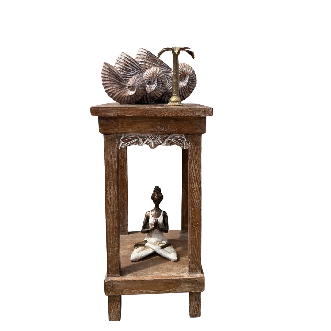Wooden side table with decorative items including a sculpture and a bowl on a white background