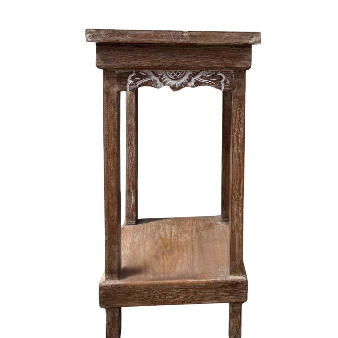 Wooden side table with decorative carvings on a white background