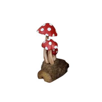 Red Top Mushroom Carving Three spotted caps with distressed paint and pale stems on a broad, irregular timber base against a white background