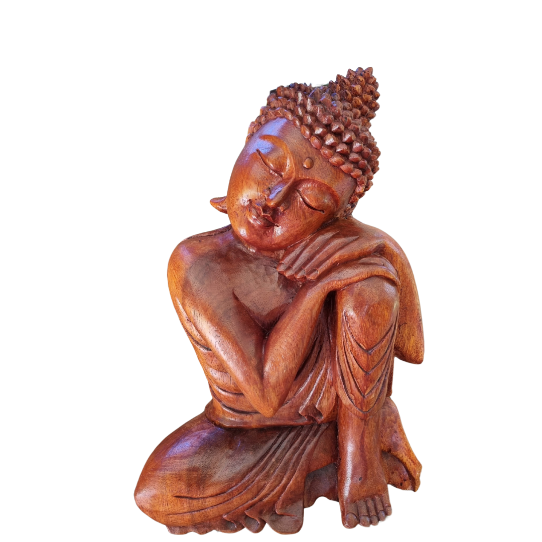 Wooden statue of a meditating Buddha on a white background