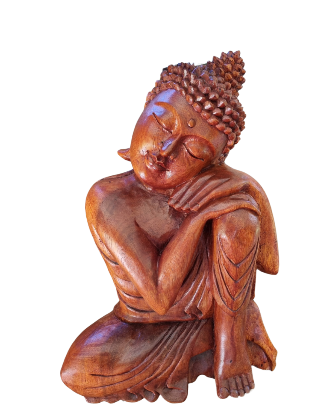 Wooden statue of a meditating Buddha on a white background