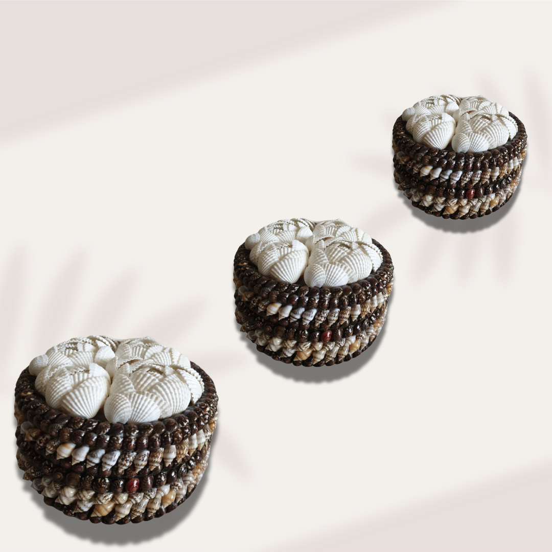 Open round trinket box with a black interior and a white shell-covered lid finished with dark beaded trim.