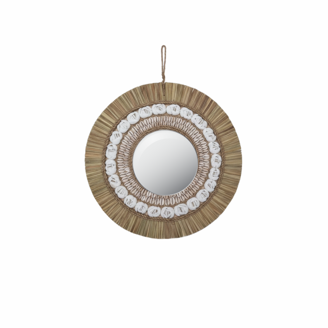 Natural tone boho coastal wall mirror with raffia fringe and cowrie shell detail, styled above a Balinese carved timber console with monstera and coastal decor — 40x40cm — handcrafted coastal boho home decor by Azure Decor