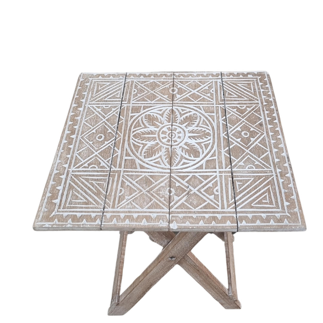 Rustic boho foldable wooden side table with hand carved geometric tribal pattern and natural matte wash finish, folding cross legs, on grey background — Boho Natural Wash design 40cm x 40cm x 50cm by Azure Decor