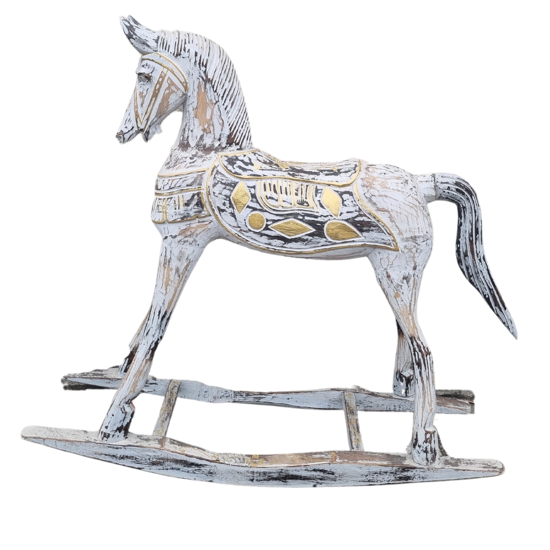 Left-facing profile of a large hand-carved wooden rocking horse with distressed white paint finish and gold geometric saddle detailing