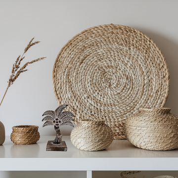 Woven baskets and decorative items on a white surface with a neutral background brown wash wooden coco tree 