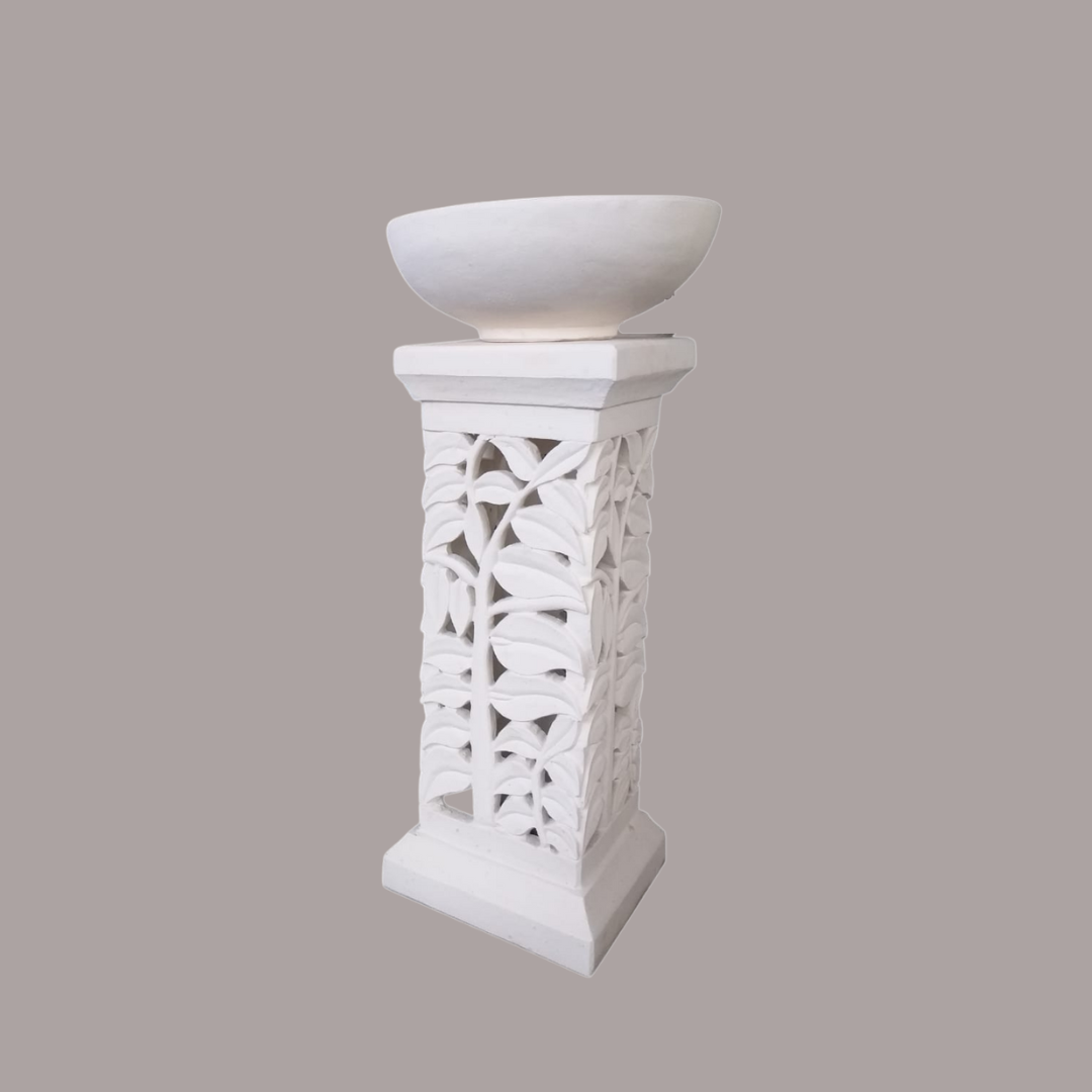 White decorative pedestal with a bowl on a gray background