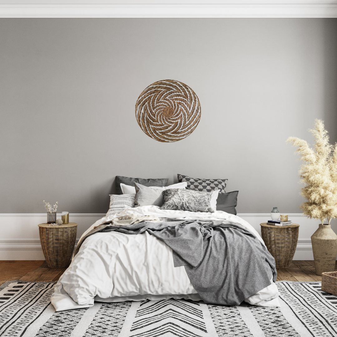 Cozy bedroom with gray walls, a bed with patterned bedding, and decorative elements.