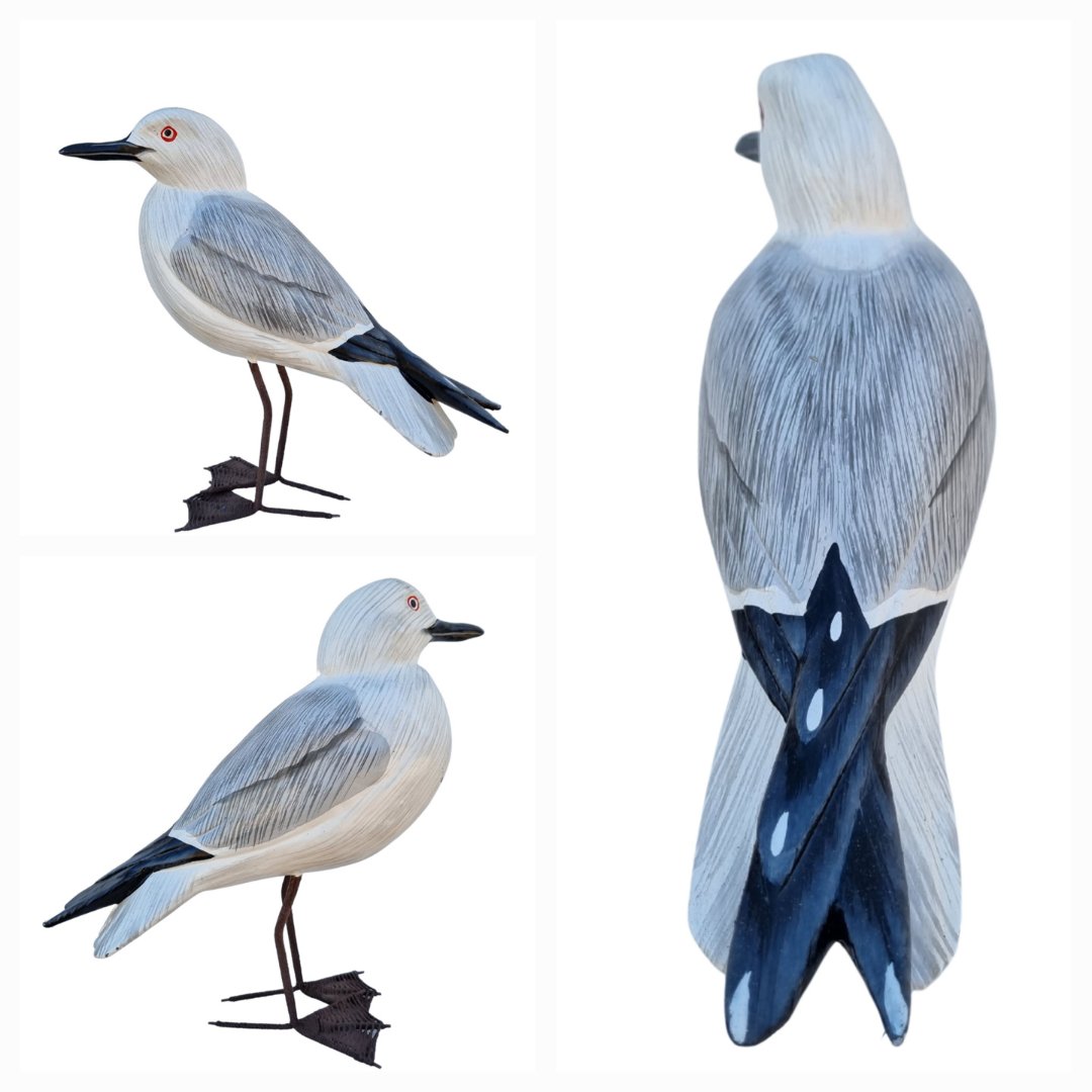 Three bird decoys with gray and white plumage on a white background