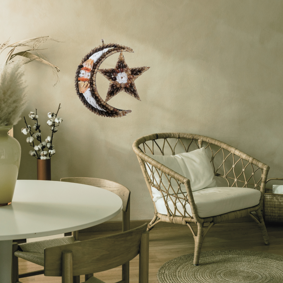 Decorative wall art of a star and crescent moon above a dining area with a table and chairs.