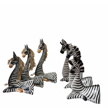 2 sets each set has one set with beige mane the other black mane both resting on a white back ground